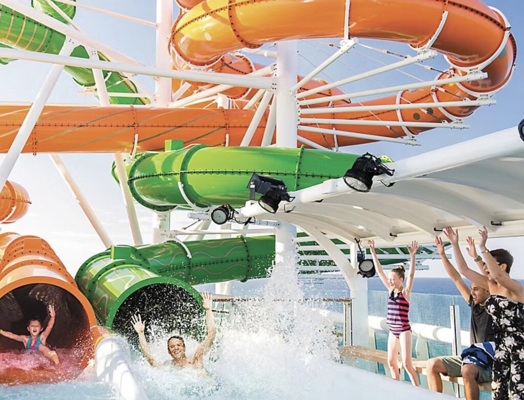 Colorful Royal Caribbean twin racers waterslides with excited riders racing